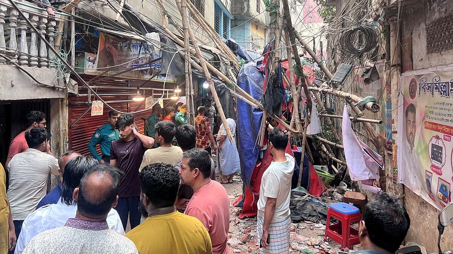 <div class="paragraphs"><p>Residents stand in an alley after vacating their house next to a fallen scaffolding following an earthquake in Dhaka, Bangladesh, November 21, 2025.</p></div>