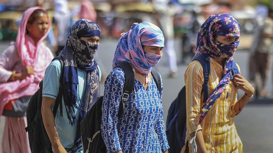 <div class="paragraphs"><p>Girls cover their face to protect themselves from the scorching heat.</p></div>