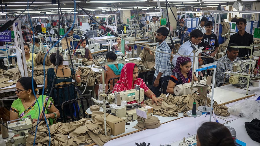 Workers stitch dresses at a garment manufacturing unit in Noida, India, August 27, 2025. REUTERS/Adnan Abidi
