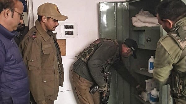 <div class="paragraphs"><p>Security personnel inspect lockers at a hospital, in Kulgam.</p></div>