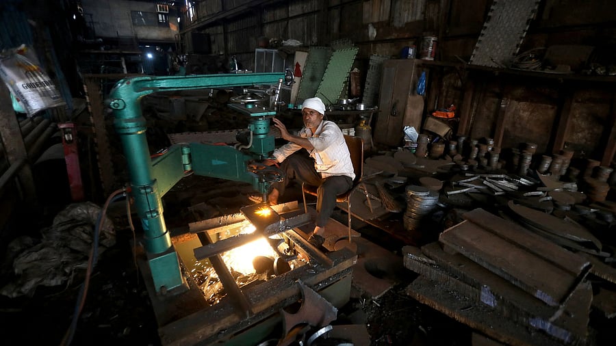 <div class="paragraphs"><p>A worker operates a machine inside a small scale manufacturing unit in Mumbai. </p></div>