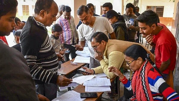<div class="paragraphs"><p>Booth Level Officers check and collect enumeration forms as voters arrive to submit them for the special intensive revision (SIR) of electoral rolls, in Prayagraj. (Image for representation)</p></div>
