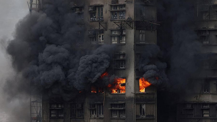 <div class="paragraphs"><p>Thick smoke billows from the upper floors of a residential block </p></div>