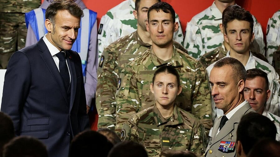 <div class="paragraphs"><p>France’s President Emmanuel Macron meets service personnel after he unveils a new national military service at the military base in Varces, French Alps.</p></div>