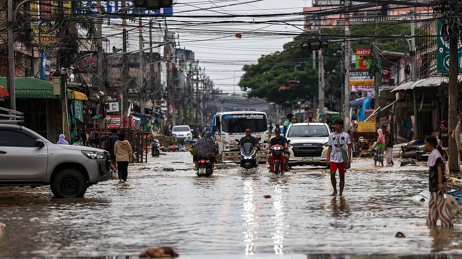 <div class="paragraphs"><p>People commute through a flooded area in Hat Yai district, Songkhla province, Thailand, November 28, 2025.</p></div>