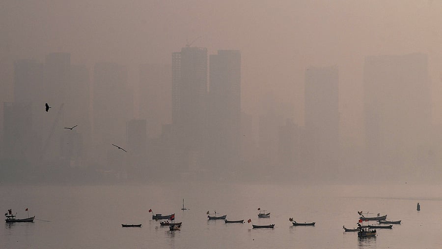 <div class="paragraphs"><p>Boats with the city skyline on a hazy day, in Mumbai,</p></div>