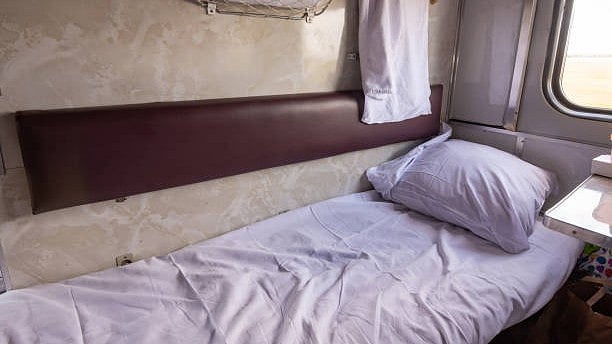 <div class="paragraphs"><p>Representative image of a bed along with a bed sheet and pillow inside a train.</p></div>