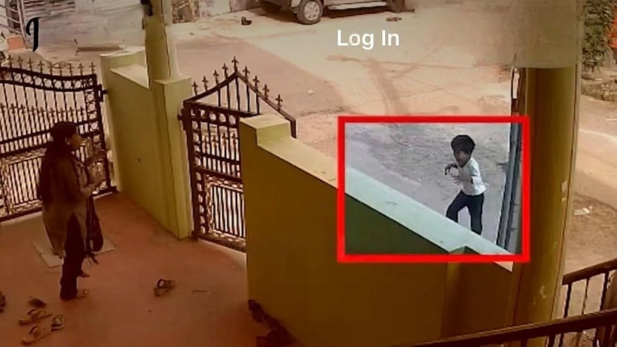 In this CCTV grab, the child runs back home in pain after being run over by the car.