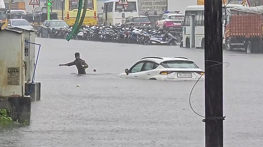 <div class="paragraphs"><p>A man wades past a stuck vehicle in the stagnant water following Cyclone Ditwah, in Chennai, Monday, Dec. 01, 2025.</p></div>