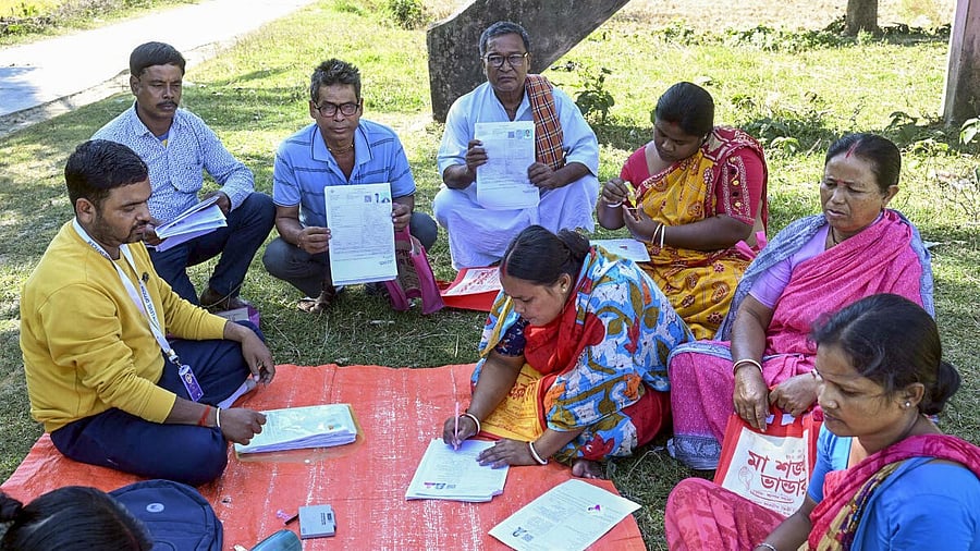 <div class="paragraphs"><p>A Booth Level Officer (BLO) oversees the filling of enumeration forms by voters for the special intensive revision (SIR) of electoral rolls, in Malda district, West Bengal.</p></div>