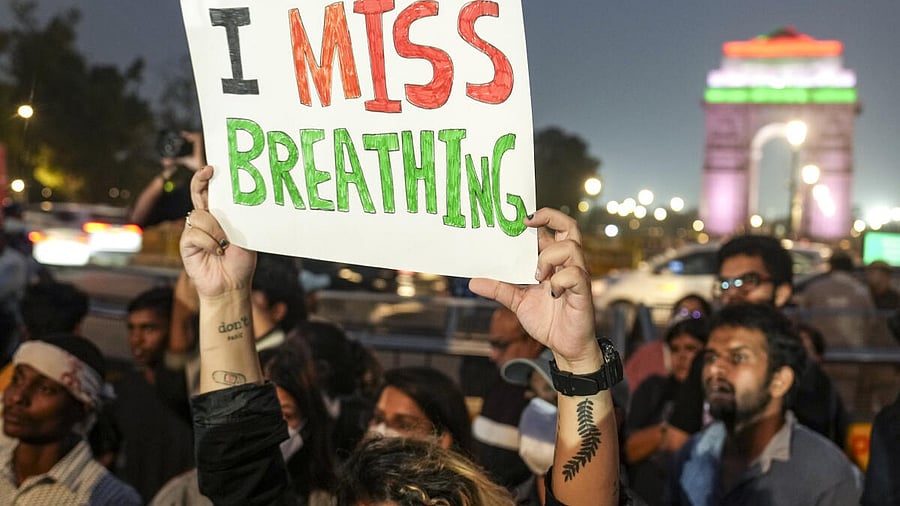 <div class="paragraphs"><p>File image of a demonstrator holding a placard during a protest over the deteriorating air quality in the national capital region, in New Delhi</p></div>