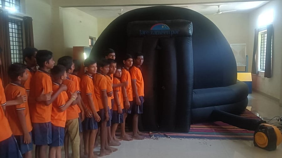 Students from a government school queue up to visit the Mobile Digital Planetarium, introduced by the Karnataka Science and Technology Promotion Society through the Shaale Angaladalli Taralaya programme.