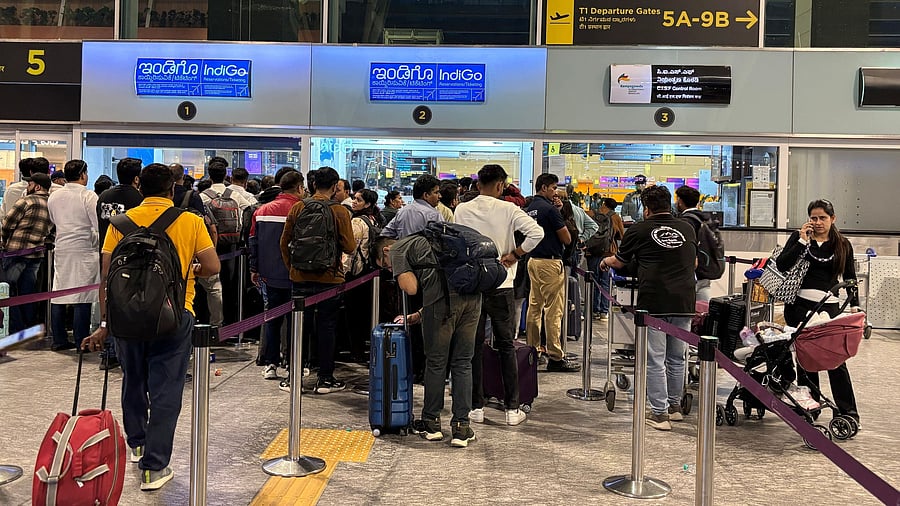 <div class="paragraphs"><p>Travellers wait at IndiGo ticketing kiosks at Kempegowda International Airport in Bengaluru on Wednesday. </p></div>