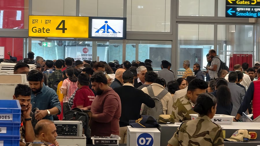 <div class="paragraphs"><p>Passengers crowd outside a boarding gate as they wait to board a delayed IndiGo flight.</p></div>