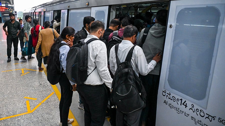 <div class="paragraphs"><p>Commuters try to enter the Green line metro train at Rastriya Vidyalaya Metro Station in Bengaluru. </p></div>