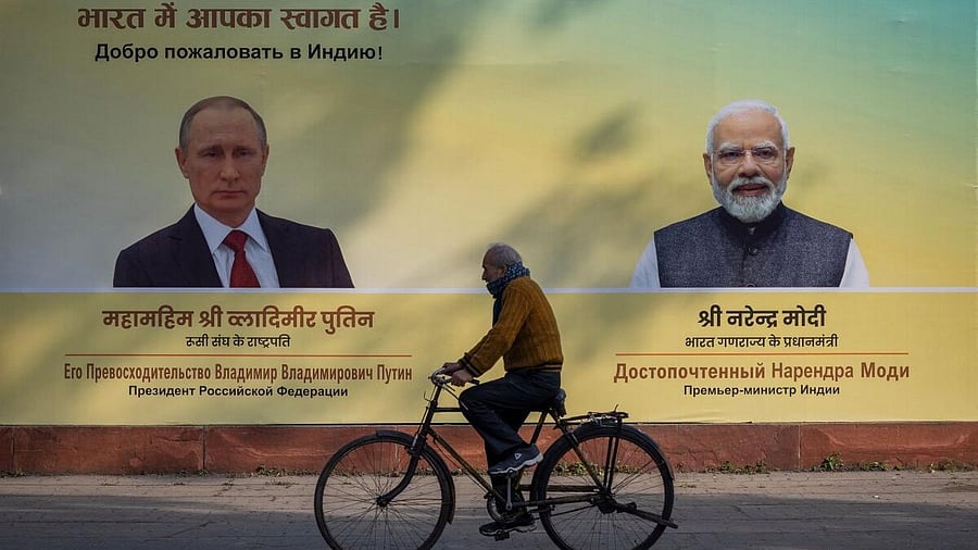 <div class="paragraphs"><p>A man cycles past a hoarding with images of Russian President Vladimir Putin and Indian Prime Minister Narendra Modi ahead of Putin's visit, in New Delhi, India,</p></div>