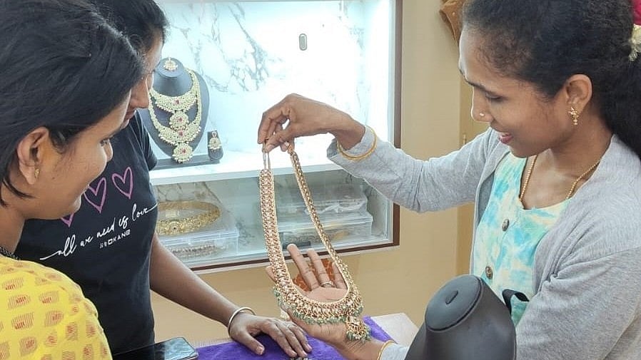 <div class="paragraphs"><p>A staff member showcases jewellery to a customer at a rental store in J P Nagar. </p></div>