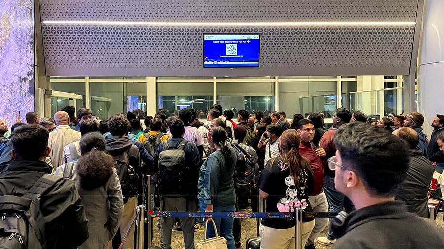 <div class="paragraphs"><p>Passengers crowd outside a boarding gate as they wait to board a delayed IndiGo flight at Indira Gandhi International airport in New Delhi.</p></div>