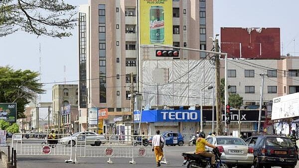 <div class="paragraphs"><p>Traffic moves along on a road at the junction Saint-Michel next to a roadblock, following reports of a coup attempt underway against the government of Benin's President Patrice Talon, in Cotonou, Benin.</p></div>