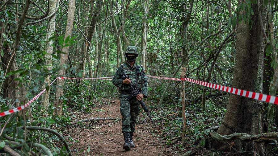 <div class="paragraphs"><p>A Thai military personnel walks near Thai-Cambodian border at Chong Chub Ta Mok area</p></div>