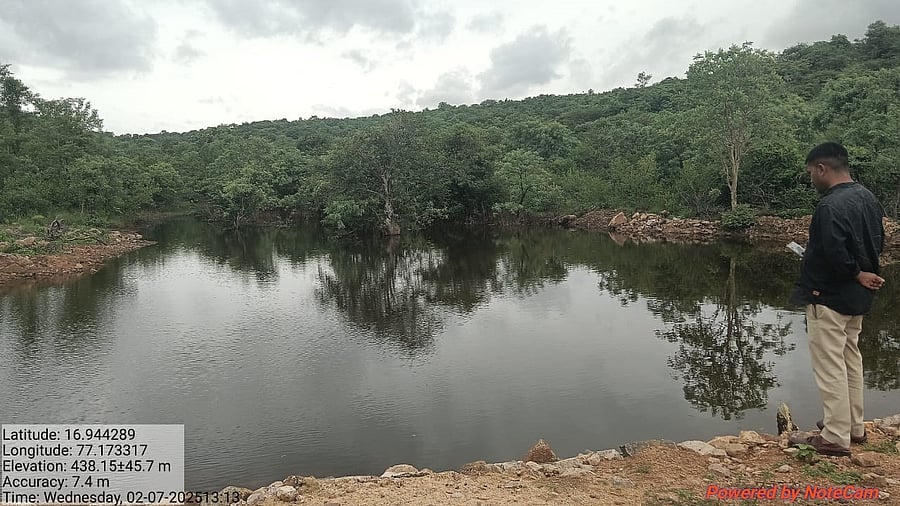 A forest personnel inspects the lake bund in Ashnal block forest in Chittapur, Kalaburagi district.