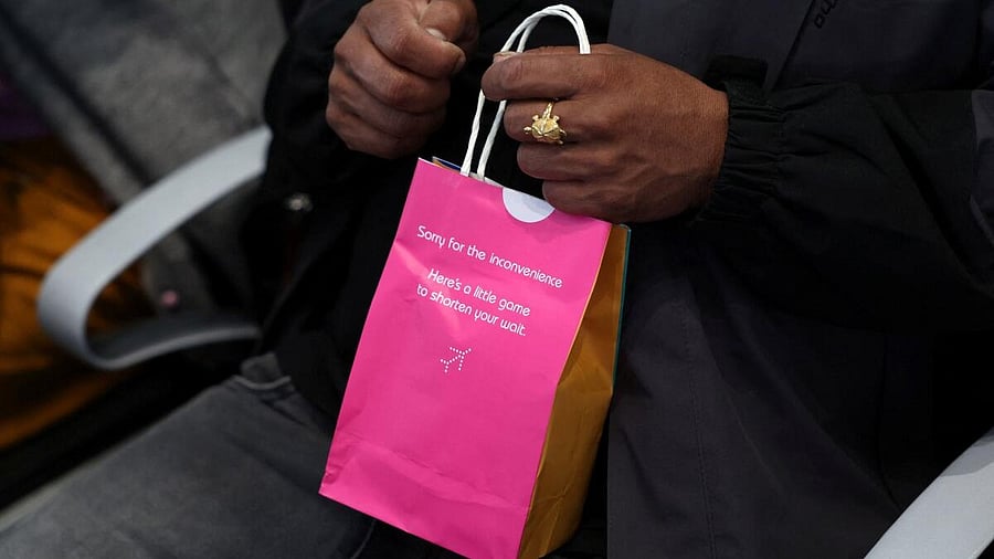 <div class="paragraphs"><p>A passenger of IndiGo holds a snacks bag given to him by the airlines staff after his flight was delayed, at Terminal 1 of Indira Gandhi International Airport in New Delhi, India, December 8, 2025.</p></div>