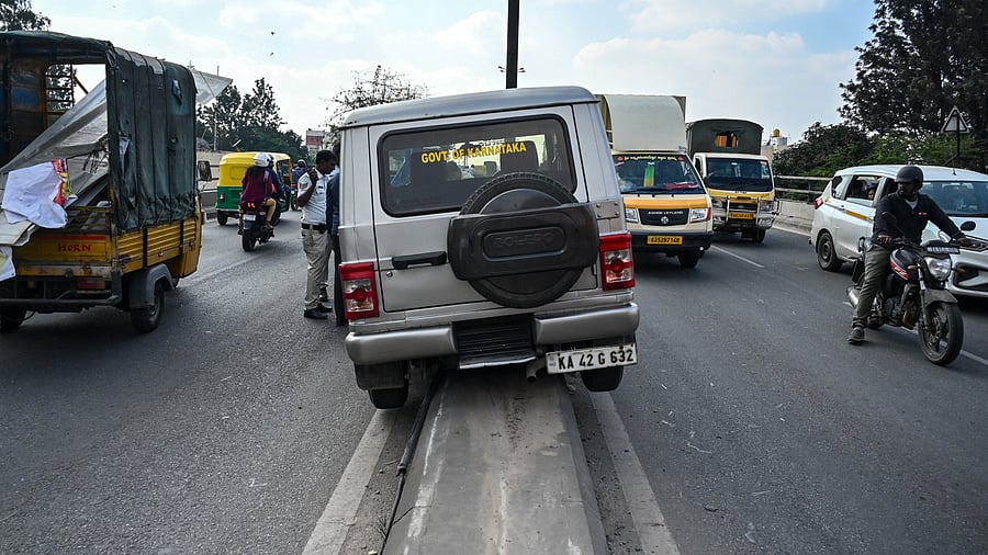 The SUV wedged atop a divider after the driver loses control while overtaking. DH PHOTO/PUSHKAR V