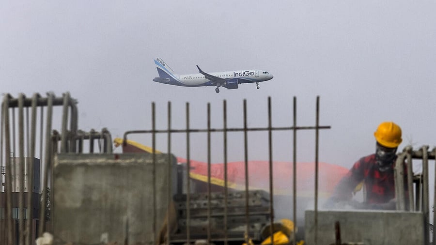 <div class="paragraphs"><p>An IndiGo aircraft prepares to land at Kempegowda International Airport as construction work in progress on the Namma Metro bridge, in Bengaluru, Karnataka, Tuesday, Dec. 9, 2025.</p></div>