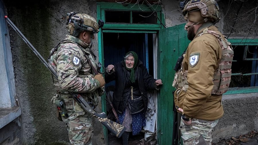 <div class="paragraphs"><p>Members of the White Angels police evacuation unit speak with a resident during an evacuation from the frontline town of Dobropillia, Ukraine, amid Russia's attack on Ukraine, in Donetsk region, Ukraine.</p></div>