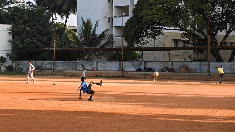 Children play football in the afternoon at Nandan Ground. The ground is free and can be accessed throughout the day. DH PHOTOS/PUSHKAR V