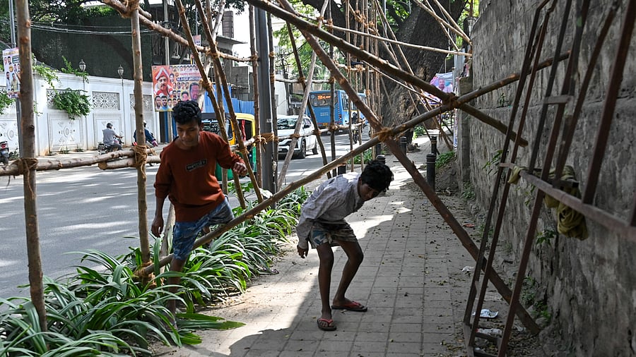 Encroached, broken footpaths push pedestrians onto the road. DH FILE PHOTO