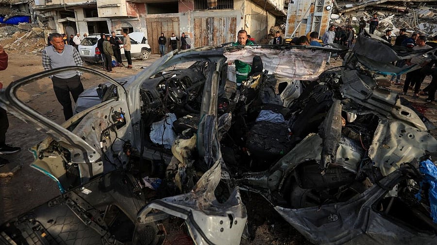 <div class="paragraphs"><p>Palestinians inspect the site of an Israeli strike on a car in Gaza City, December 13, 2025.</p></div>