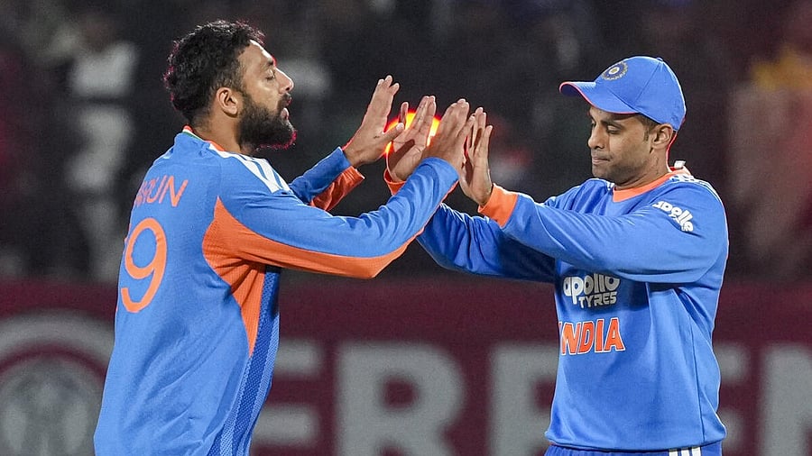 <div class="paragraphs"><p>India’s Varun Chakravarthy, left, celebrates with captain Suryakumar Yadav after taking the wicket of South Africa's Marco Jansen during the third T20 International cricket match of a series between India and South Africa, at HPCA Stadium, in Dharamshala, Himachal Pradesh, Sunday, Dec. 14, 2025.</p></div>