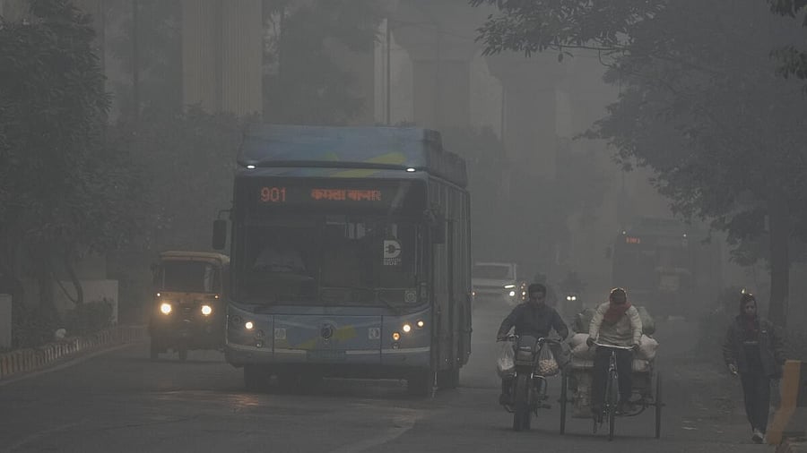 <div class="paragraphs"><p>Vehicles move on a road amid low visibility due to a layer of smog, in New Delhi, Sunday, Dec. 14,</p></div>