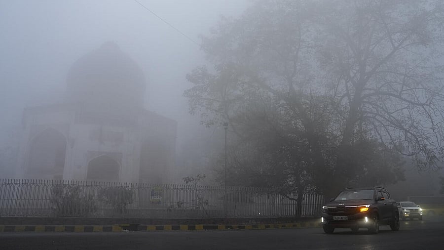 <div class="paragraphs"><p>Commuters make their way on a foggy winter morning, in New Delhi.</p></div>