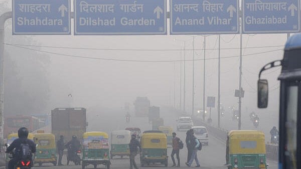 <div class="paragraphs"><p>Vehicles move on a road amid low visibility due to a layer of smog, in New Delhi</p></div>