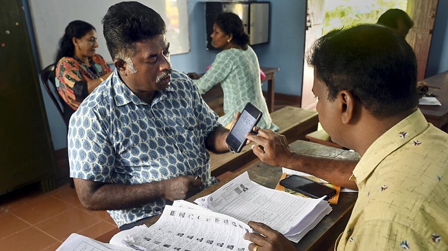 <div class="paragraphs"><p>A Booth Level Officer (BLO) interacts with a voter as he checks and collects filled enumeration forms for the special intensive revision (SIR) of electoral rolls. </p></div>