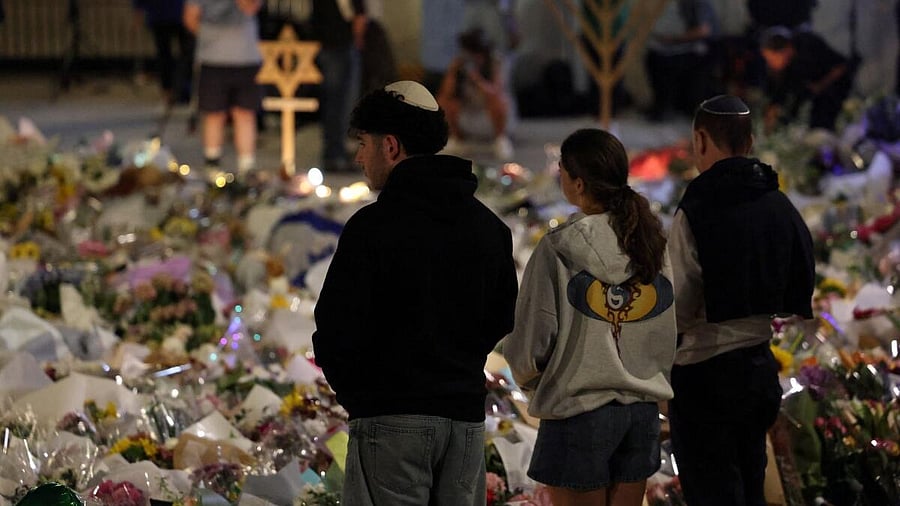 <div class="paragraphs"><p>People look at floral tributes laid to honour victims of a shooting at Jewish holiday celebration on Sunday at Bondi Beach, in Sydney, Australia.</p></div>
