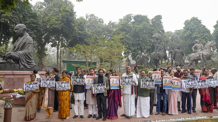<div class="paragraphs"><p>Opposition members hold placards during a protest march at the Parliament House complex amid its ongoing Winter session</p></div>