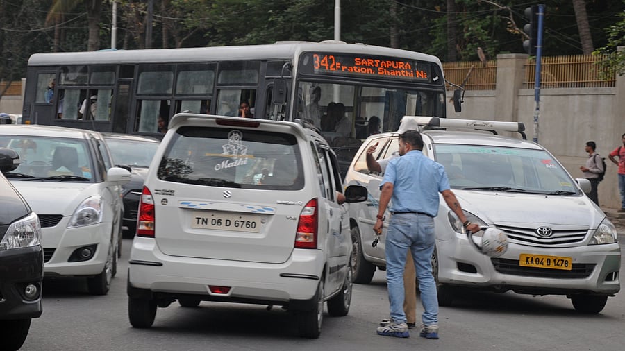 In a fit of road rage, a Motorist fighting with car driver, who is jumped signal at Kormangala in Bangalore on Thursday. Photo by S K Dinesh
Road rage incidents are on a high in the city.