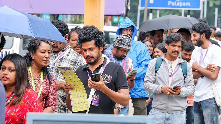 <div class="paragraphs"><p>Film buffs going through the screening schedule at IFFK 2025. </p></div>