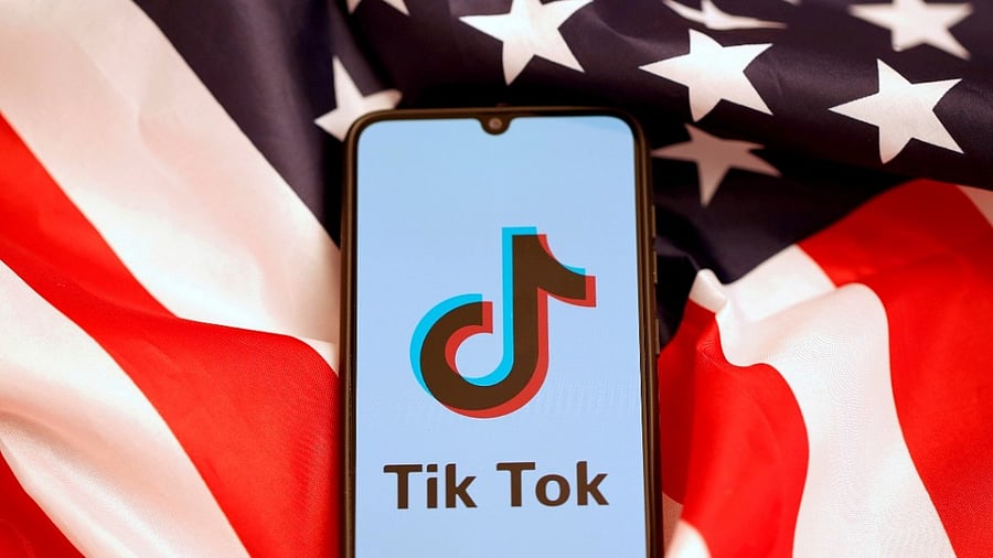 <div class="paragraphs"><p>TikTok's logo is displayed on the smartphone while standing on the US flag. </p></div>