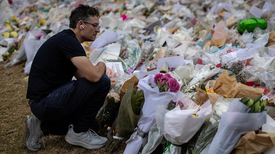 <div class="paragraphs"><p>A man kneels in front of flowers offered to honour the victims of a mass shooting during a Jewish Hanukkah celebration at Bondi Beach on December 14, in Sydney, Australia, December 19, 2025.</p></div>