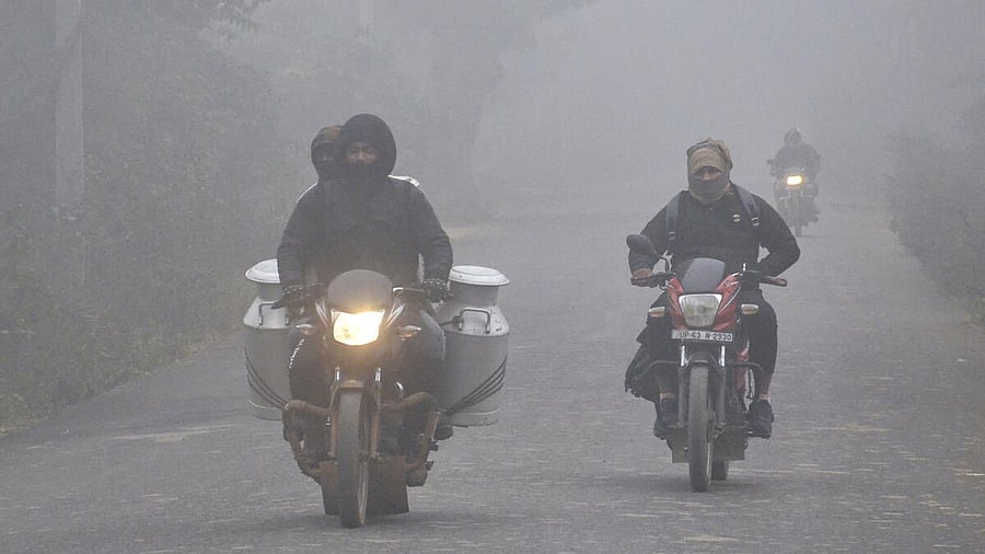 <div class="paragraphs"><p>Motorcyclists ride through fog on a cold winter morning, in Mirzapur district, Uttar Pradesh, Thursday, Dec. 18, 2025.</p></div>