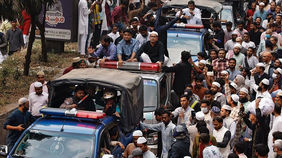 <div class="paragraphs"><p>A convoy carrying the body of Sharif Osman Hadi, a student leader, who died after being shot in the head, moves along the crowd after the funeral prayer, in Dhaka, Bangladesh, December 20, 2025.</p></div>