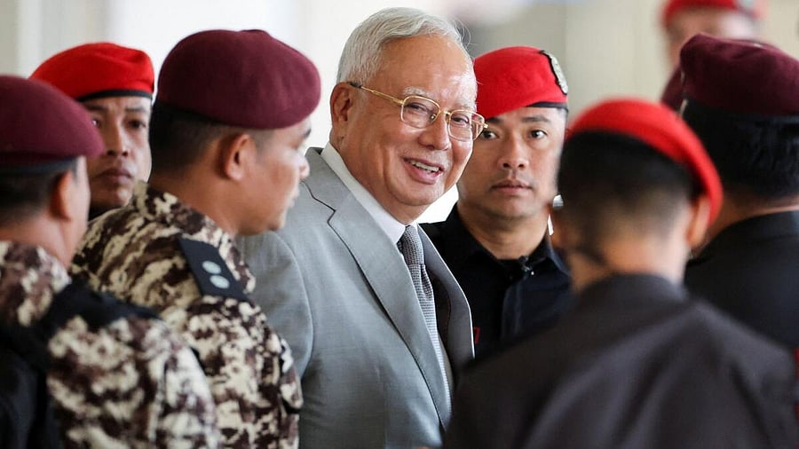 <div class="paragraphs"><p>Malaysia's former Prime Minister Najib Razak, jailed for corruption in the multibillion-dollar 1MDB scandal, is escorted by prison guards at Kuala Lumpur Courts Complex, on the day he attends the verdict of his house arrest bid, at Kuala Lumpur, Malaysia.</p></div>