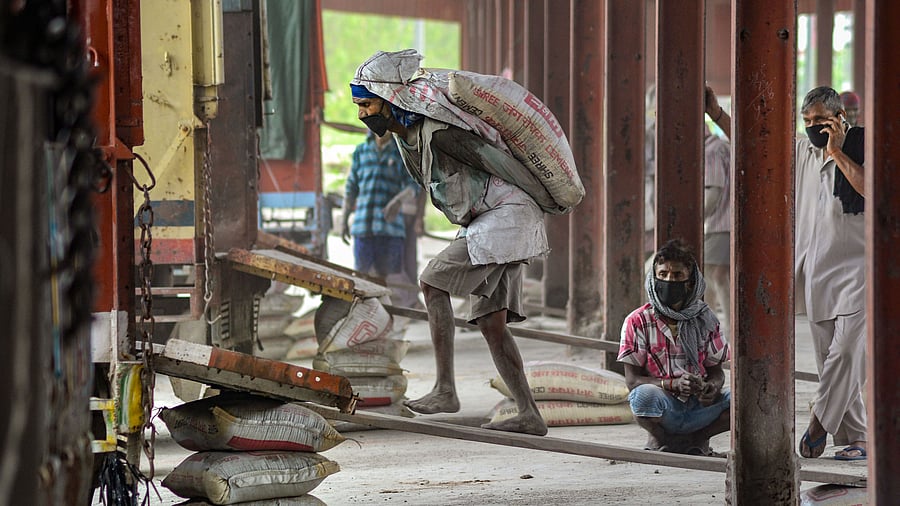 <div class="paragraphs"><p>Labourers load sacks filled with cement in a truck from a wagon, during the nationwide lockdown to curb the spread of coronavirus, in Jalandhar. </p></div>