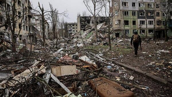 <div class="paragraphs"><p>Ukrainian serviceman walks near apartment buildings damaged by Russian military strike, amid Russia's attack on Ukraine, in the frontline town of Kostiantynivka in Donetsk region, Ukraine.</p></div>