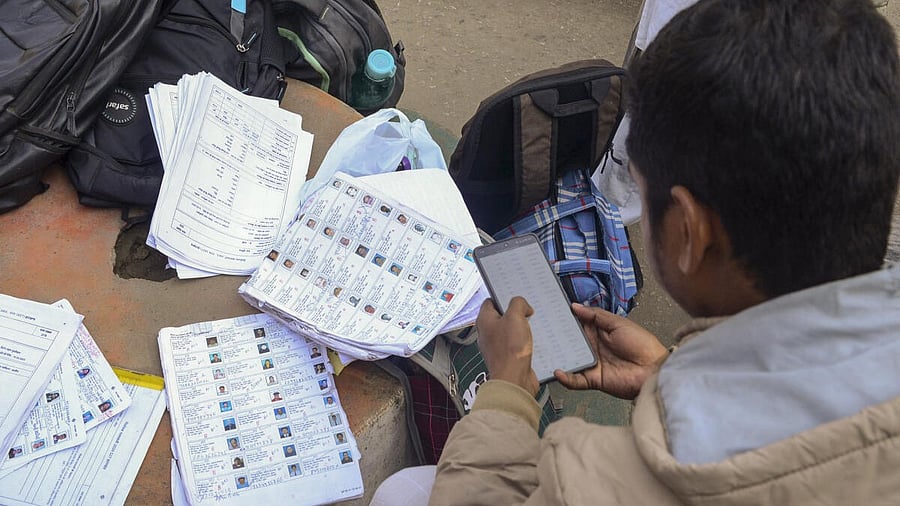 <div class="paragraphs"><p>A voter checks his name in the voter list ahead of the special intensive revision of electoral rolls in the state.</p></div>