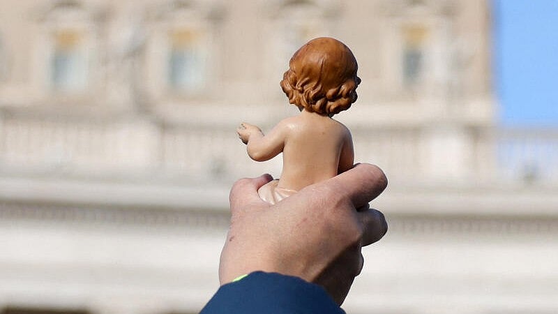 <div class="paragraphs"><p>A faithful holds a baby Jesus figurine to receive a blessing as Pope Leo XIV leads the Angelus prayer from the window of the Apostolic Palace at the Vatican, December 21, 2025.</p></div>